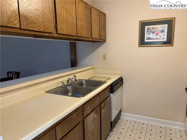 a view of a refrigerator a sink and dishwasher