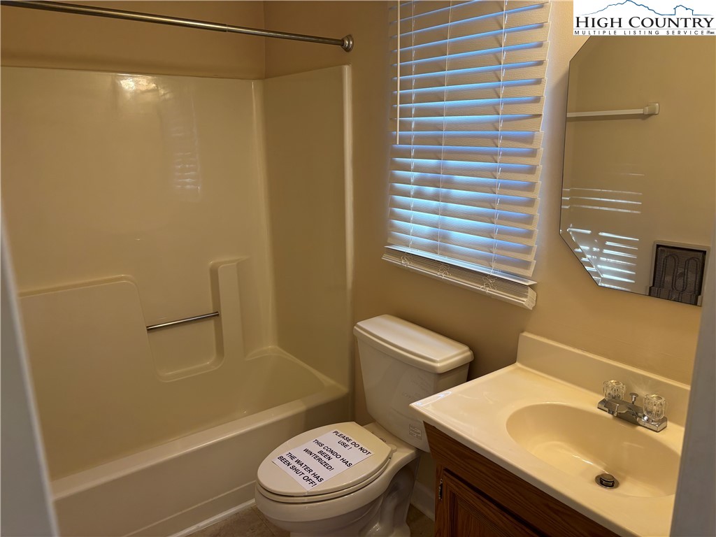 180 Village Drive, Unit 1C4 Boone, NC 28607 - Photo 10 of 23 a bathroom with a sink a toilet and shower