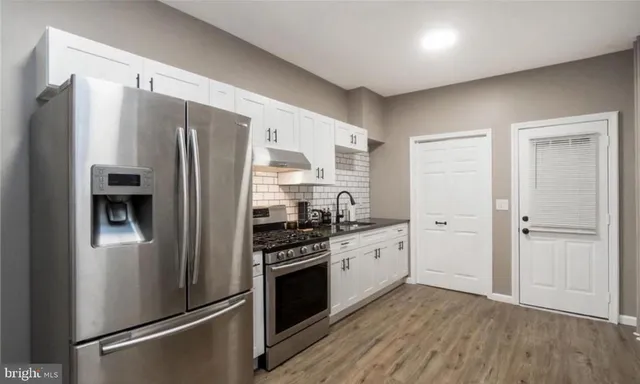 a kitchen with stainless steel appliances a refrigerator stove and sink