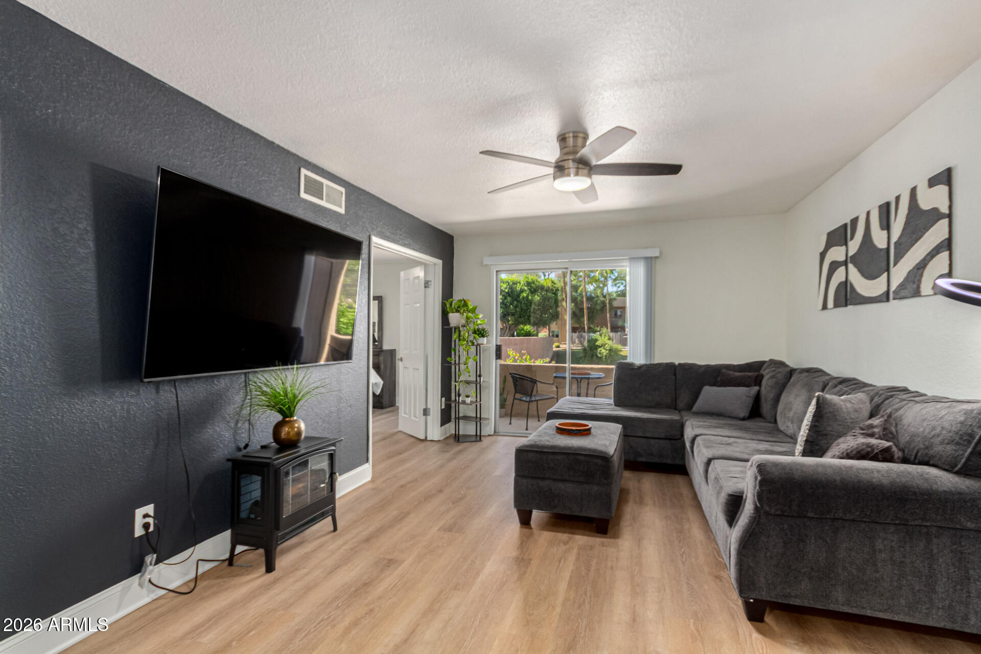 5877 North Granite Reef Road, Unit 1133 Scottsdale, AZ 85250 - Photo 5 of 33 a living room with furniture and a flat screen tv