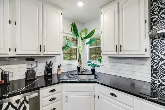 a kitchen with stainless steel appliances granite countertop a refrigerator a stove and a sink