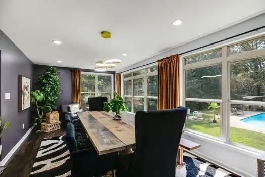 a view of a dining room with furniture window and wooden floor