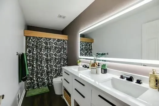 a bathroom with a tub sink and mirror