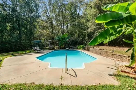 a view of a house with backyard and deck
