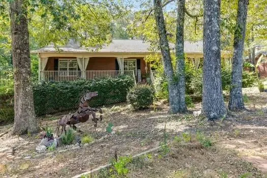 a view of a house with a yard and sitting area