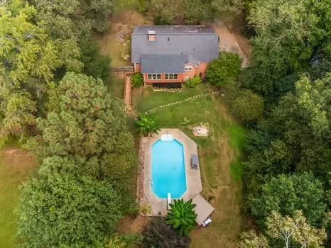 a view of a house with swimming pool yard and a patio