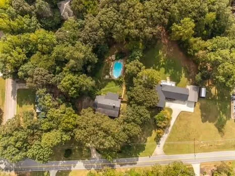 a view of a brick house with a yard table and chairs