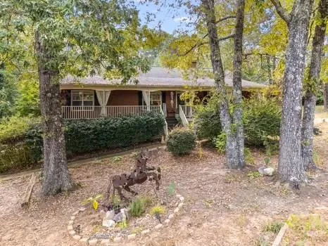 a front view of a house with yard and trees
