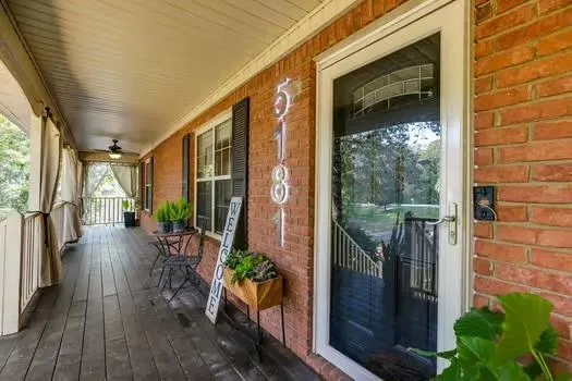 a living room with furniture a chandelier and a fireplace