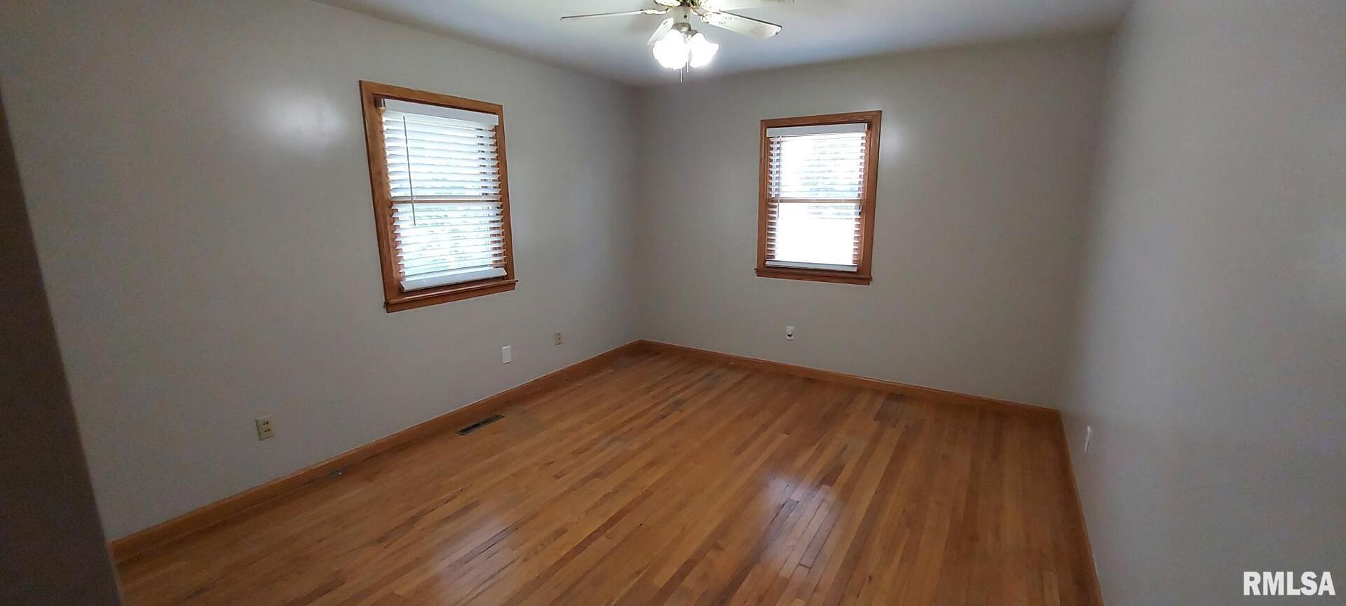 2390 Highway 150 Rio, IL 61472 - Photo 19 of 37 wooden floor in an empty room with a window
