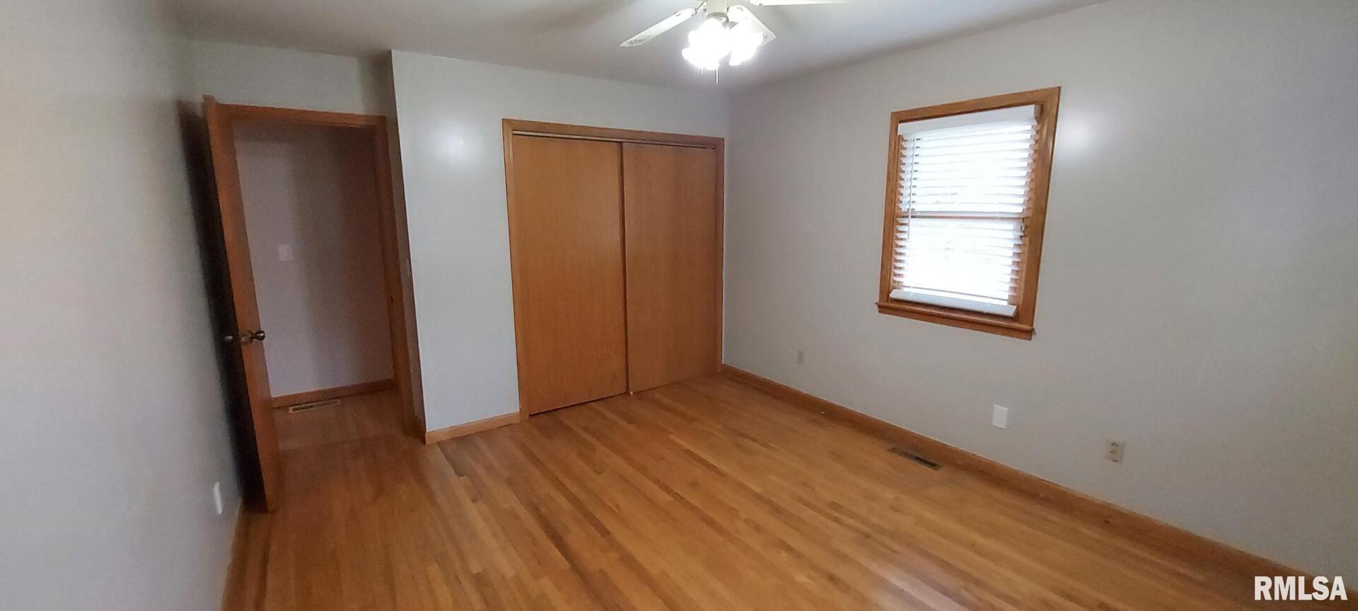 2390 Highway 150 Rio, IL 61472 - Photo 20 of 37 an empty room with wooden floor and a window