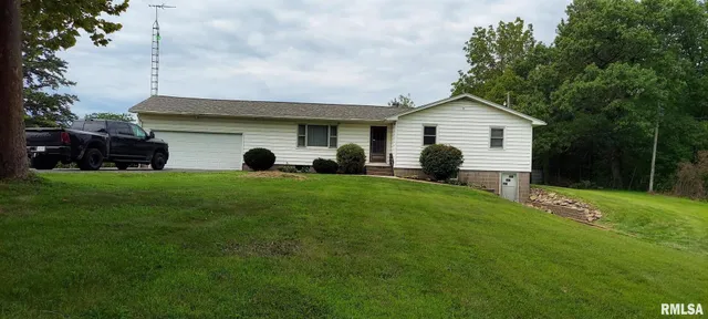 a view of a house with a backyard