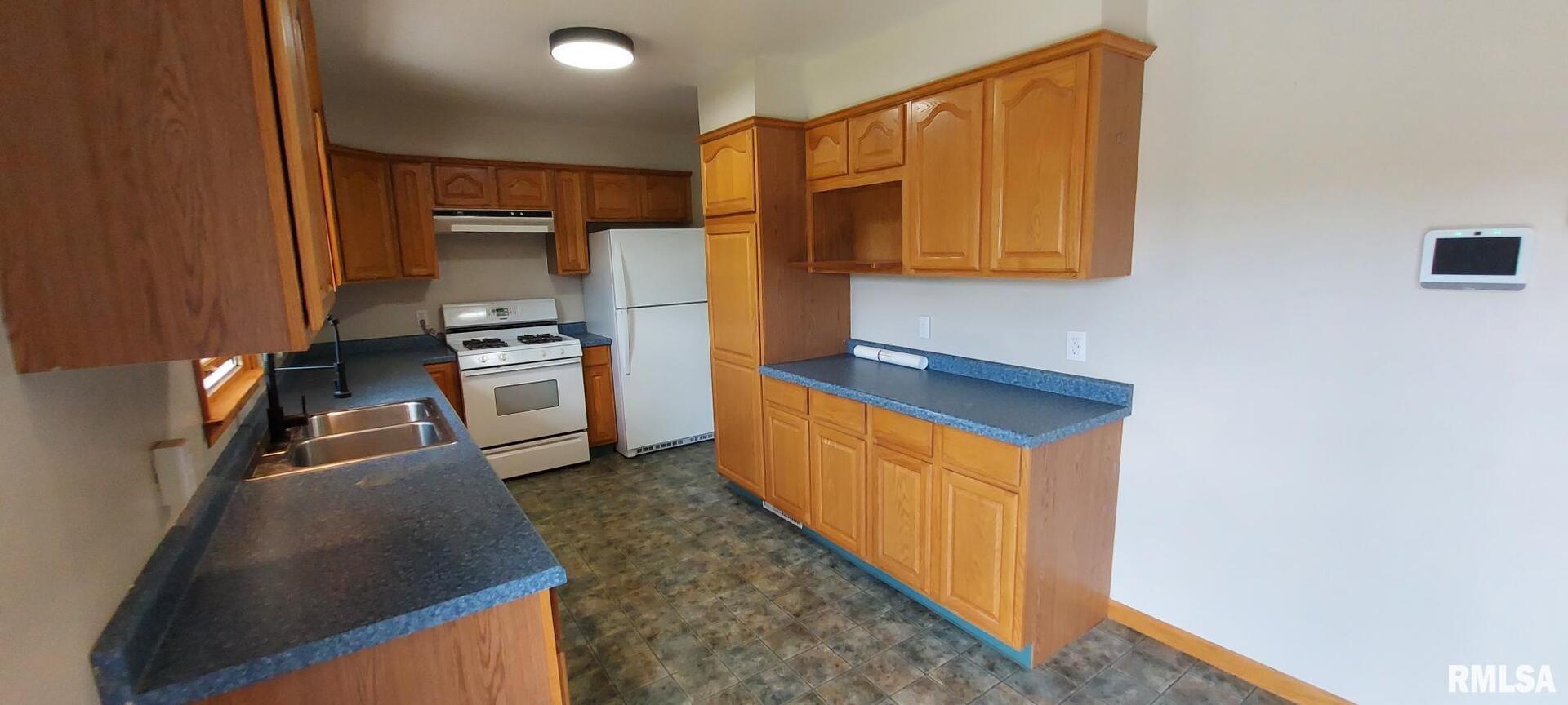 2390 Highway 150 Rio, IL 61472 - Photo 24 of 37 a kitchen with stainless steel appliances granite countertop a refrigerator a stove and a sink