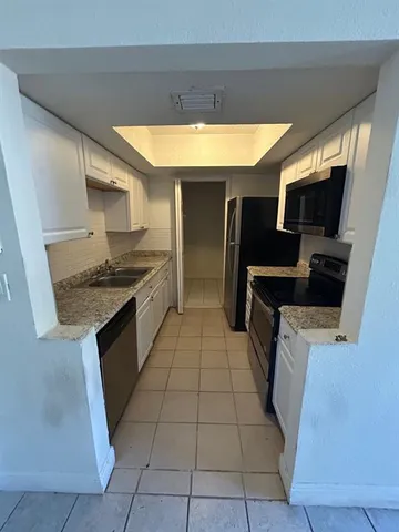 a kitchen with a sink a stove and refrigerator
