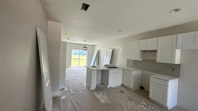 a kitchen with a sink appliances and cabinets