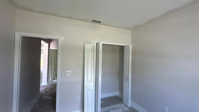 a view of a hallway with wooden shelves