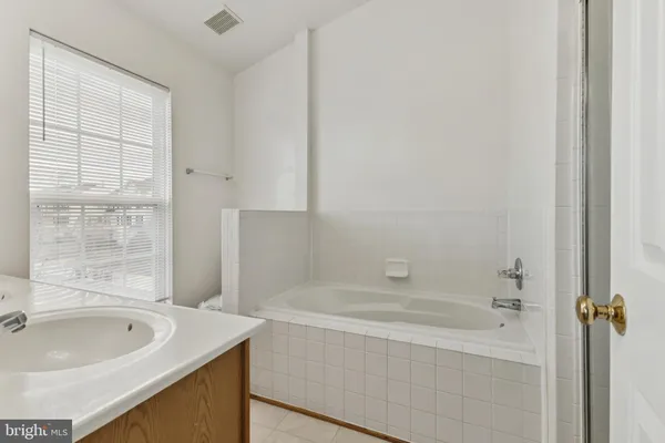 a bath tub sitting next to a white sink