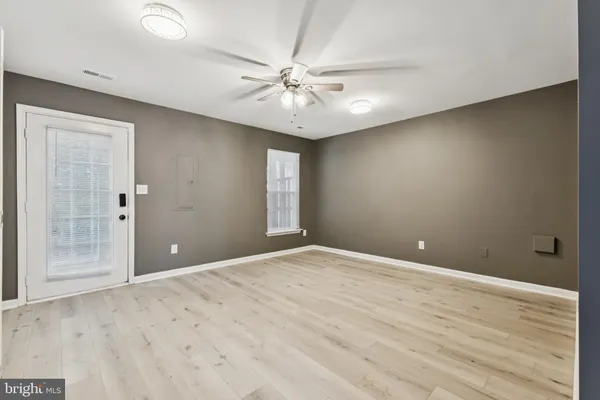 wooden floor in an empty room with a window