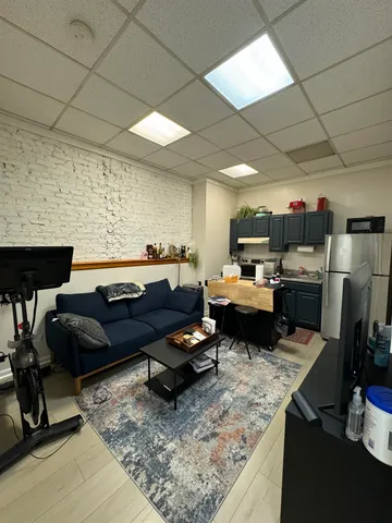 a living room with furniture and a rug