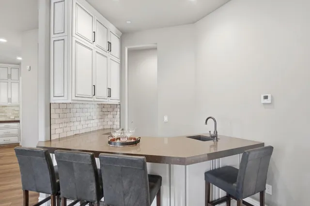 a kitchen with a sink stainless steel appliances and cabinets