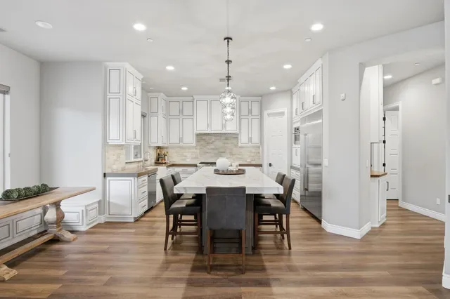a kitchen with granite countertop a sink stove and cabinets