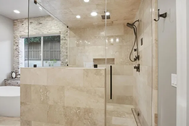 a bathroom with a sink a toilet a tub and shower