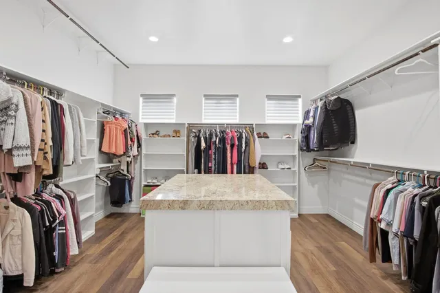 a bedroom with a bed and a book shelf