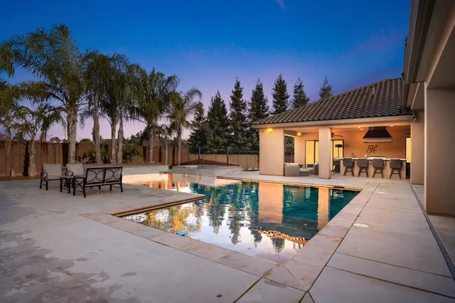 a view of a patio with swimming pool table and chairs