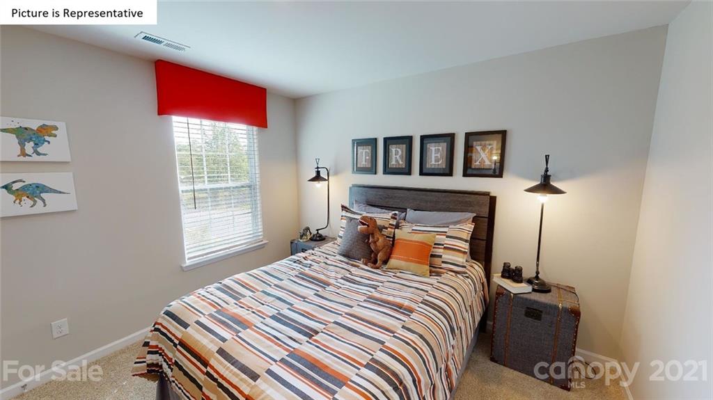 317 Gaines Road Clover, SC 29710 - Photo 22 of 36 a bedroom with a bed and wooden floor