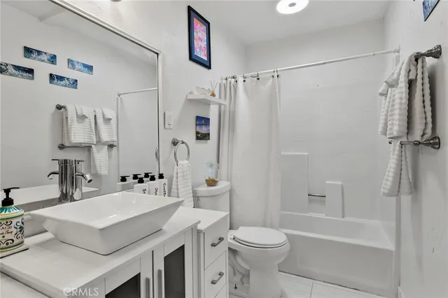 a bathroom with a sink toilet tub and shower