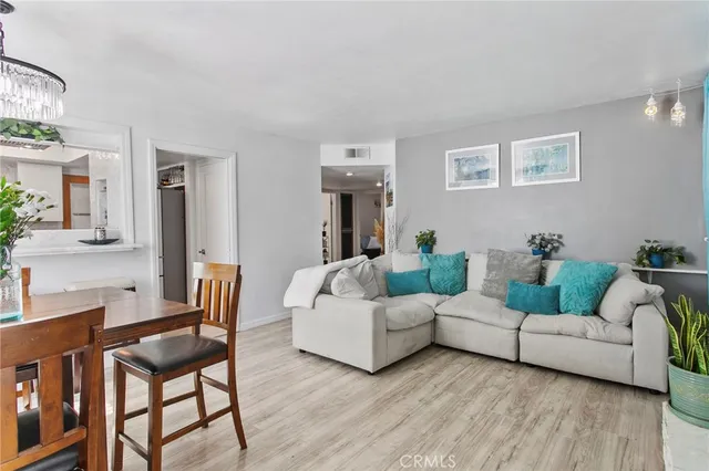 a living room with furniture and a potted plant on table