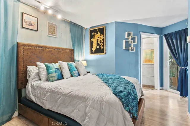 a bedroom with a large bed and a window