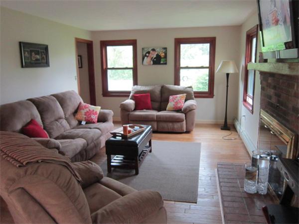 9 Halcyon Farm Road Lakeville, MA 02347 - Photo 9 of 13 a living room with furniture a flat screen tv and a window