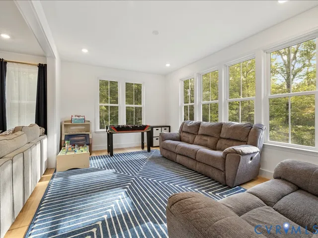 a kitchen with stainless steel appliances granite countertop a stove a sink dishwasher a refrigerator and a dining table with wooden floor