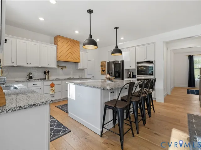 a view of a living room with furniture and floor to ceiling window