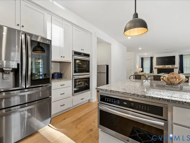 a bedroom with a bed chandelier and a window