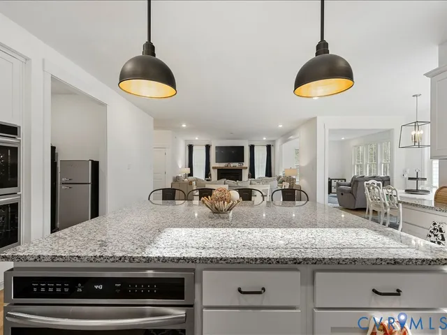 a bedroom with a bed a large window and a chandelier