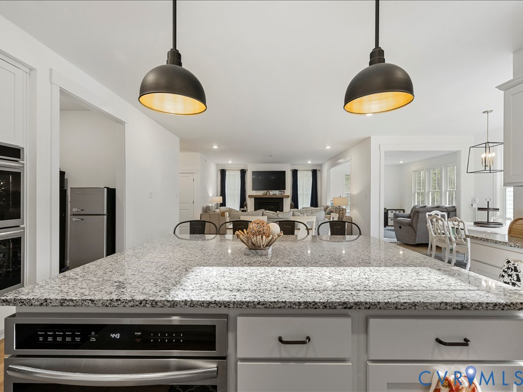 4021 Tredon Road Mechanicsville, VA 23111 - Photo 20 of 50 a kitchen with granite countertop a counter space cabinets and stainless steel appliances