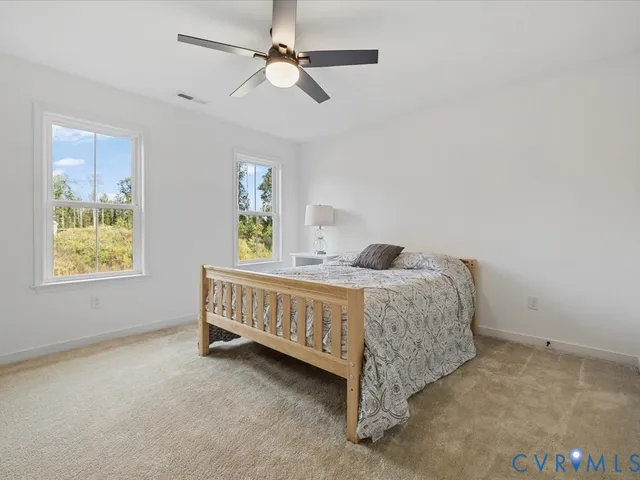 a front view of a house with a garden and yard