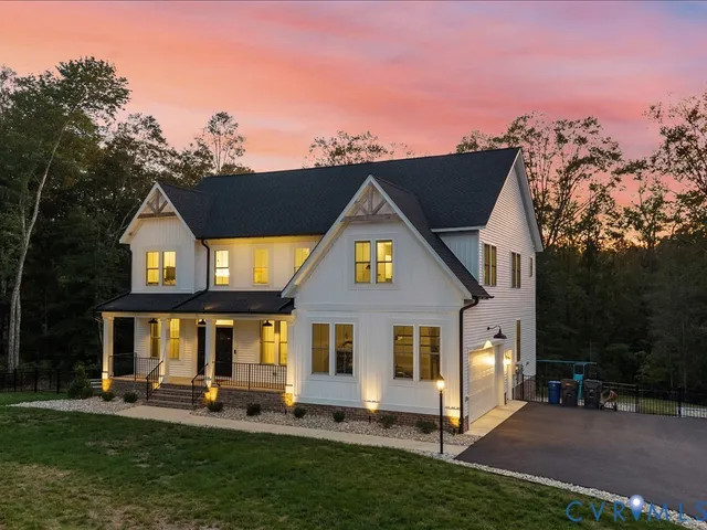 a dining room with wooden floor a chandelier a wooden table and chairs