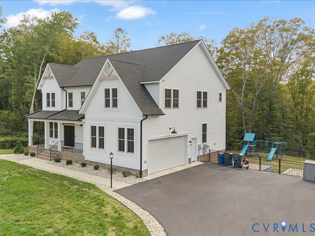 4021 Tredon Road Mechanicsville, VA 23111 - Photo 5 of 50 a view of a white house with a yard and plants
