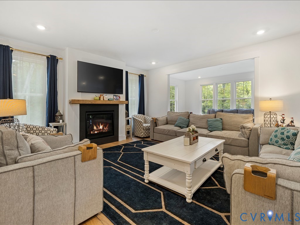 4021 Tredon Road Mechanicsville, VA 23111 - Photo 9 of 50 a living room with furniture a flat screen tv and a fireplace
