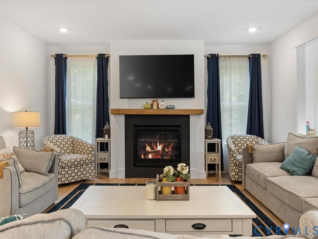 4021 Tredon Road Mechanicsville, VA 23111 - Photo 10 of 50 a living room with furniture a flat screen tv and a fireplace