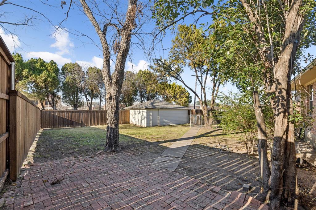 9363 Angora Street Dallas, TX 75218 - Photo 8 of 10 a view of a house with backyard and trees