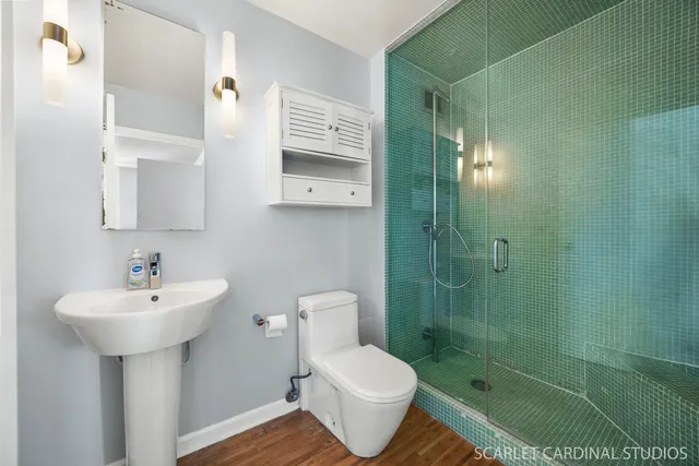 a bathroom with a sink toilet and shower