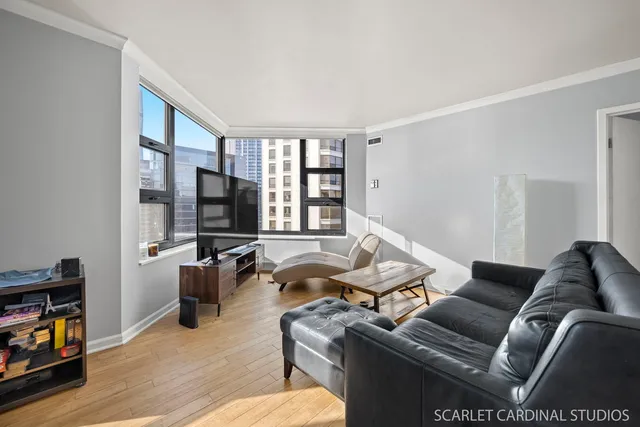 a living room with furniture window and a flat screen tv