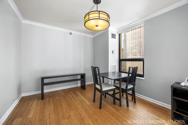 a view of a dining room with furniture and wooden floor
