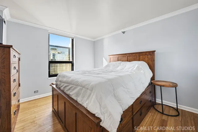 a bed sitting in a bedroom next to a window