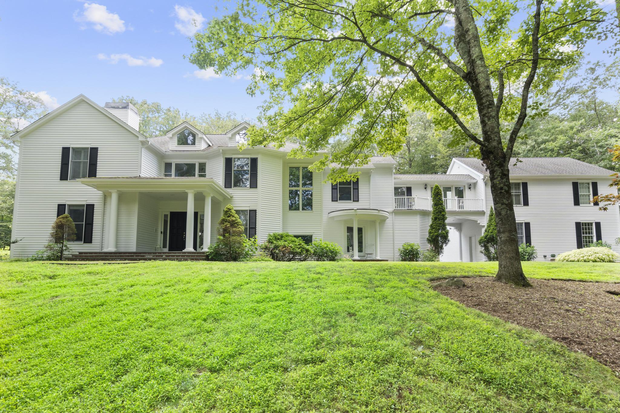 101 Brambly Hedge Circle Fairfield, CT 06824 - Photo 1 of 40 a front view of a house with a yard