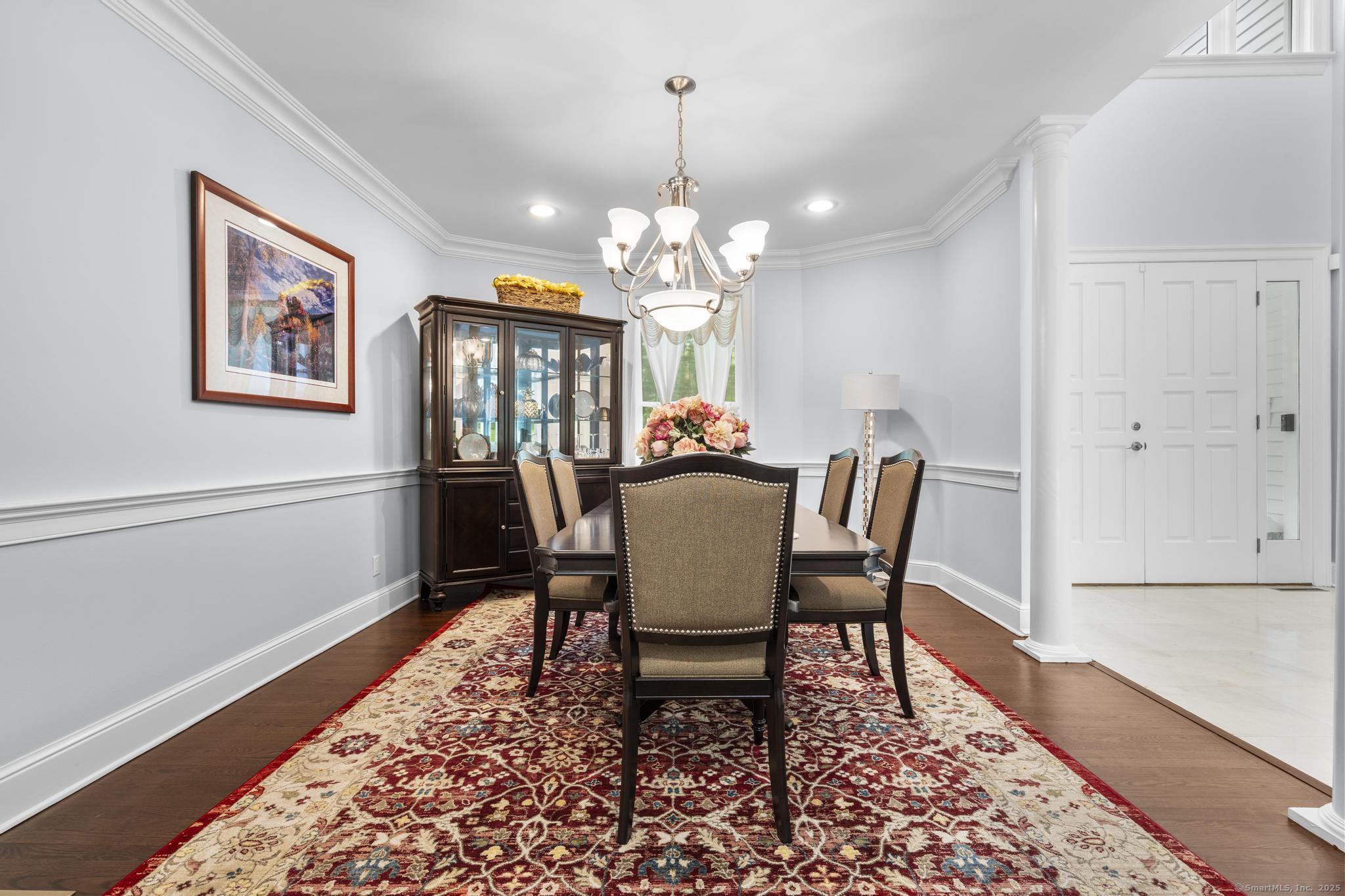 101 Brambly Hedge Circle Fairfield, CT 06824 - Photo 11 of 40 a dining room with furniture a rug and wooden floor